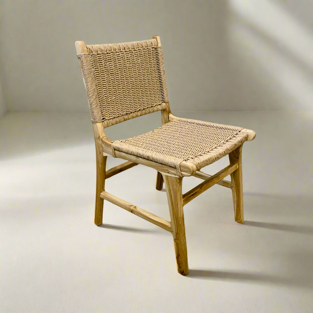 Teak dining chair with a woven seat and backrest on a plain background