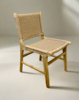 Teak dining chair with a woven seat and backrest on a plain background